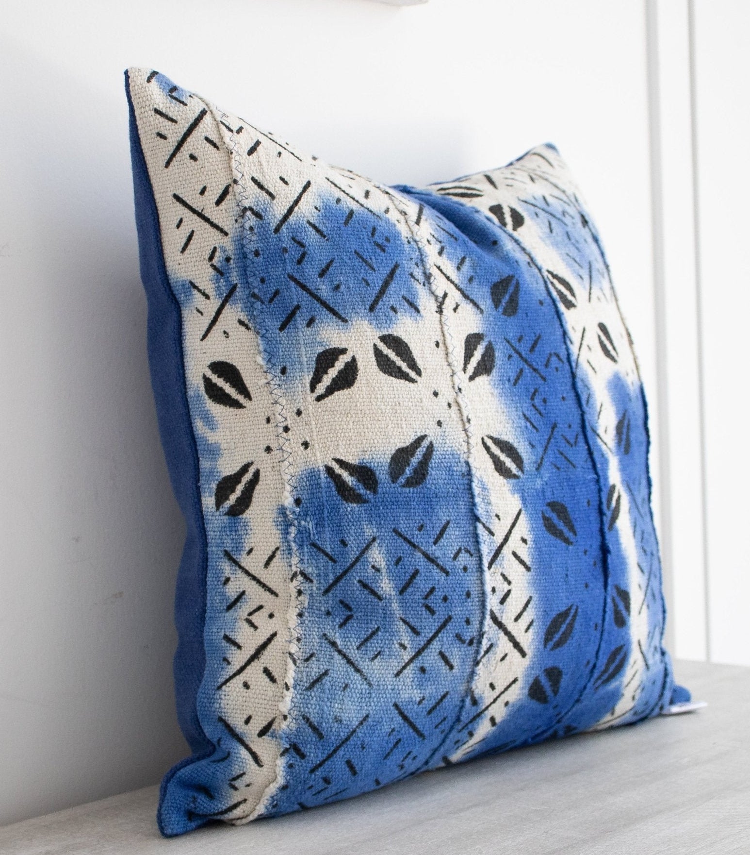 white and blue mud cloth cushion
